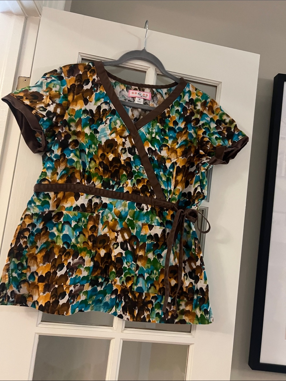 Koi Colorful Floral Wrap Scrub Top with Brown Trim